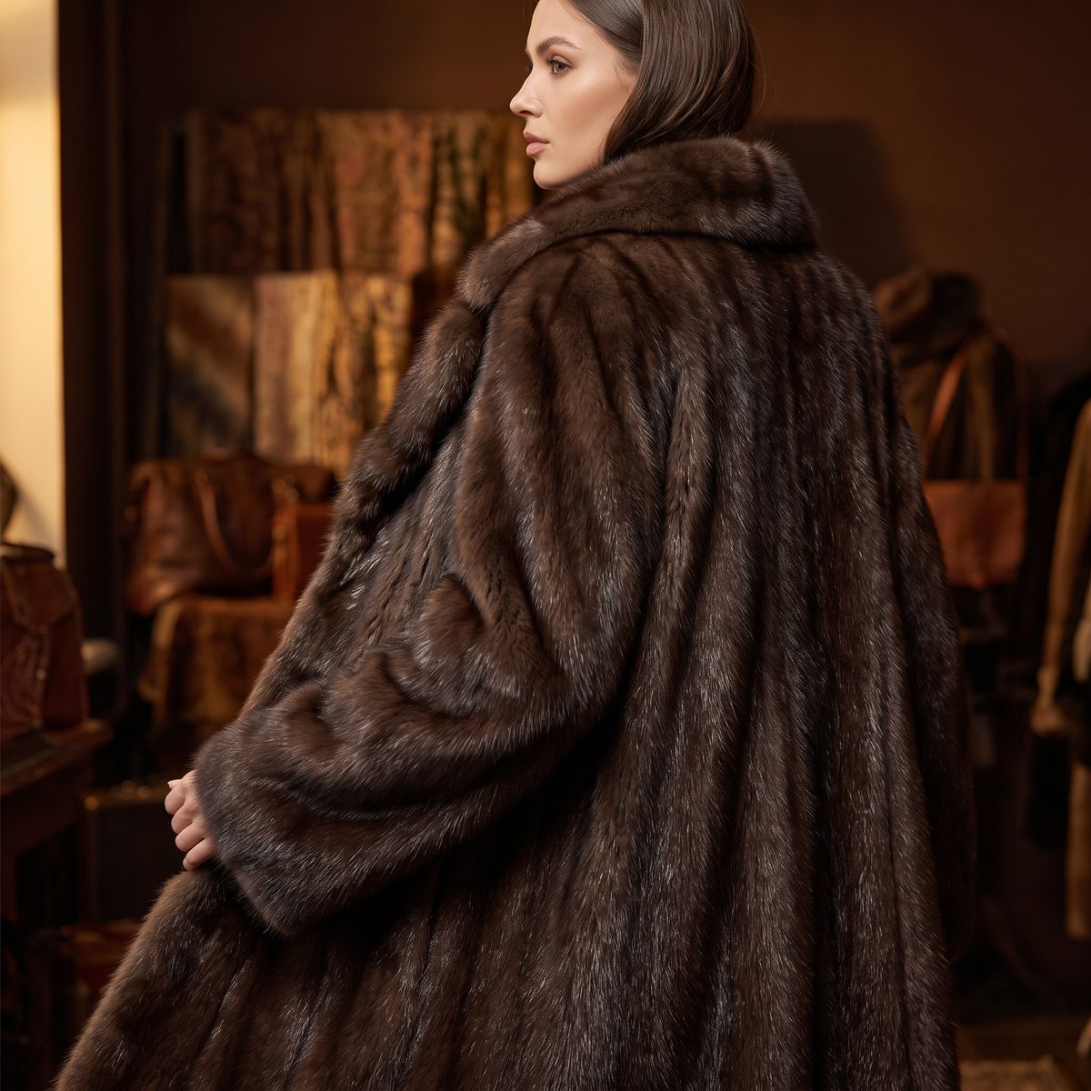 A dark sable fur coat presented in an atelier
